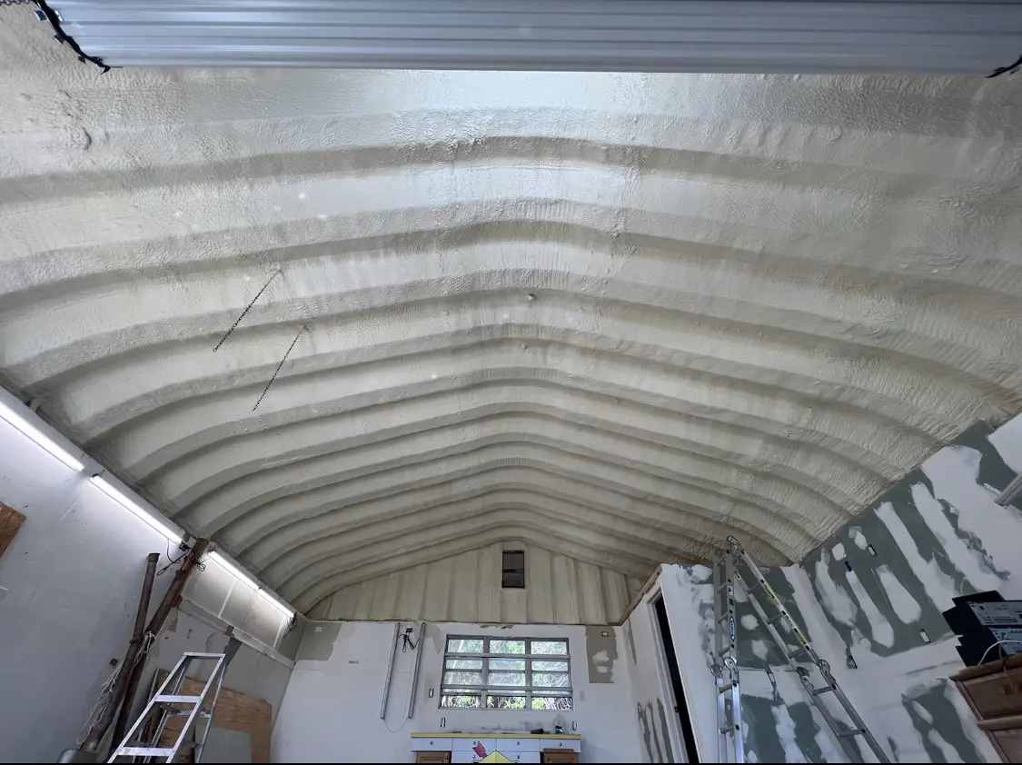 Spray polyurethane foam applied to the underside of a metal roof deck in Dracut